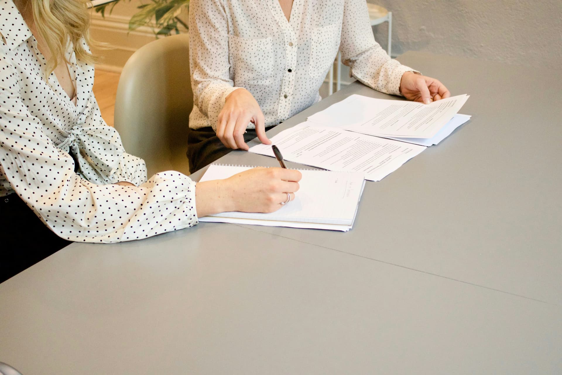 Clients signing documents at a table